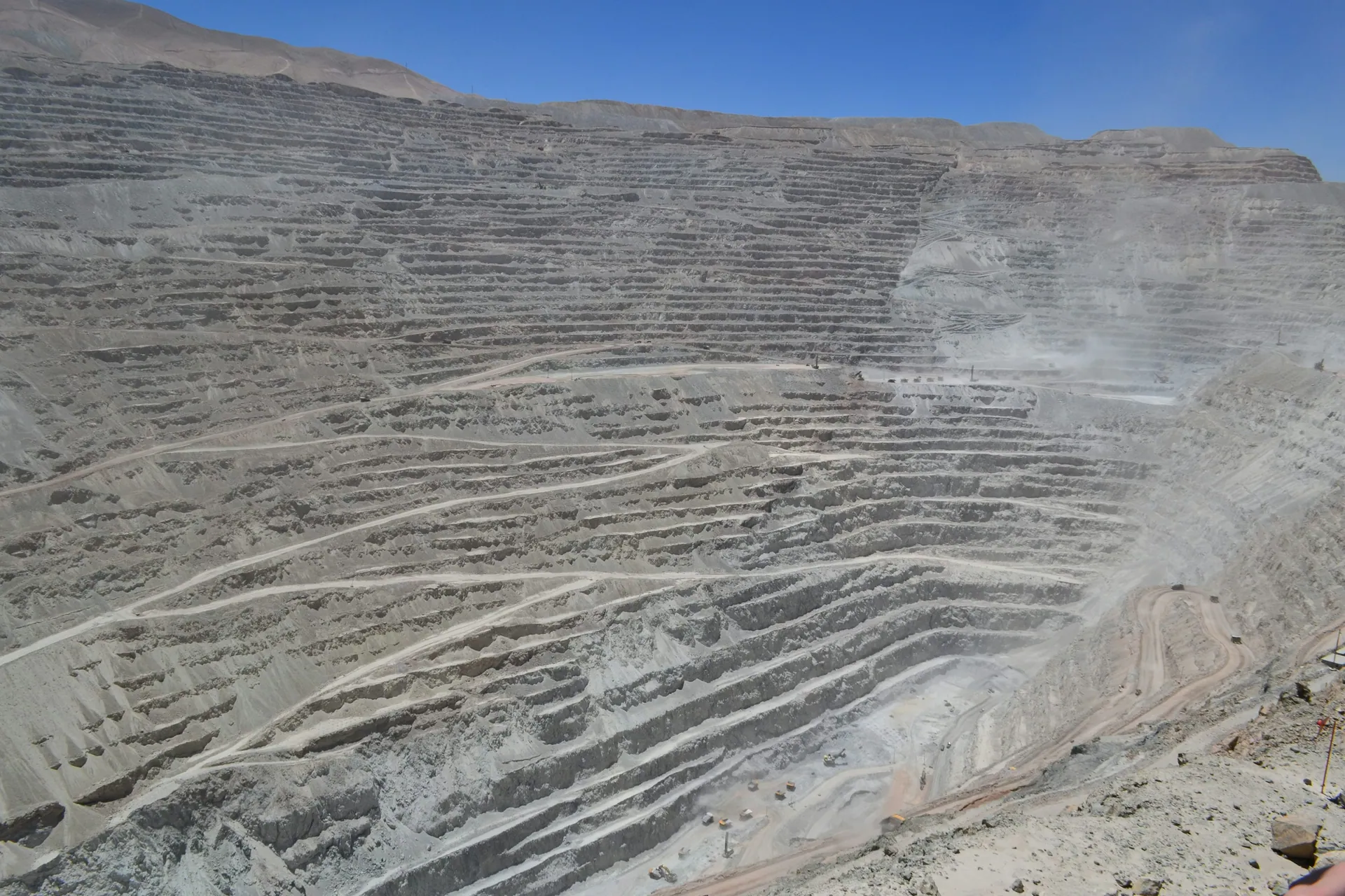 Aerial view of an open-pit surface mine with terraced benches